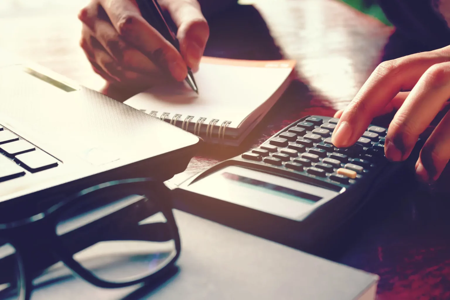 a set of hands using a calculator