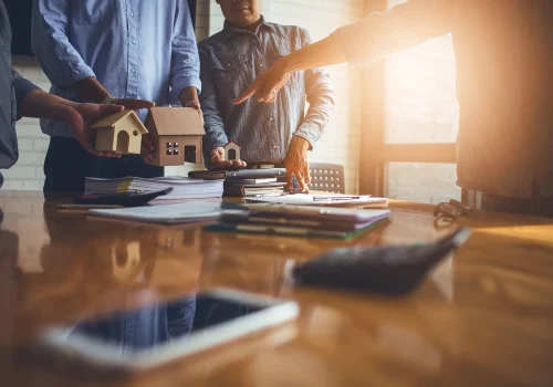 a group of real estate agents collaborating at a conference room desk