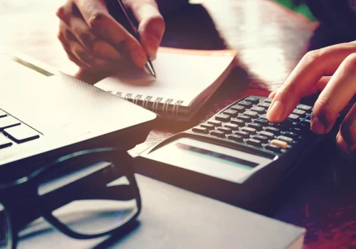a set of hands using a calculator